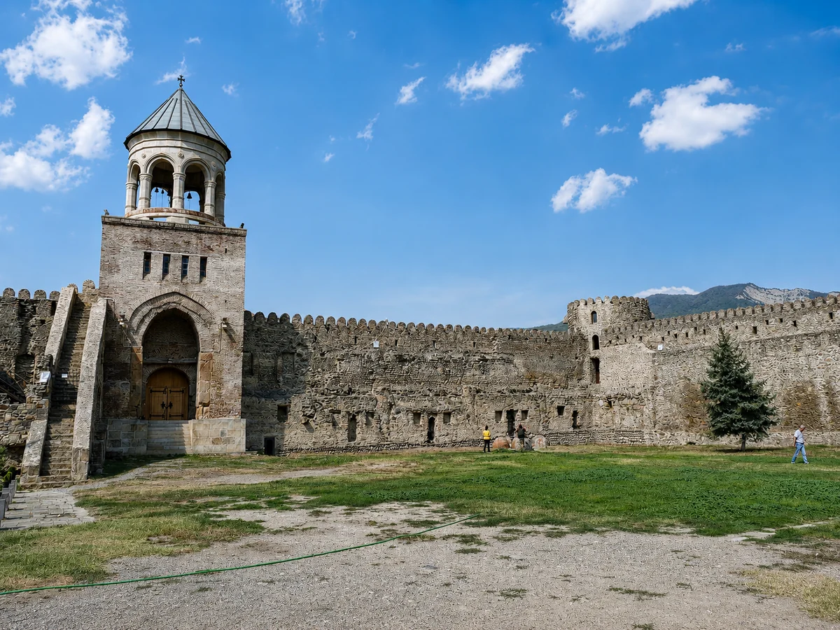 The bell tower and crenellated wall enclosing Svetitskhoveli Cathedral, Mtskheta, Georgia